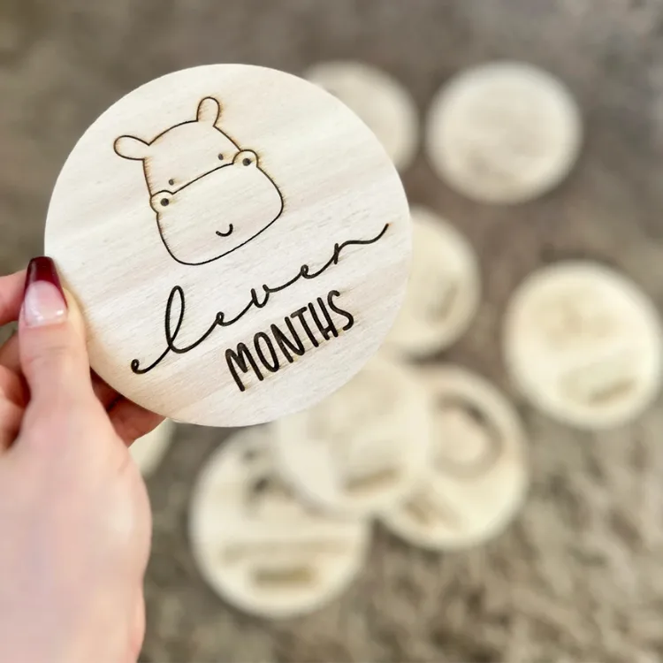 Su aygırı kazımalı eleven months kartı elde, arka planda bulanık görünen diğer Mimus Baby Safari kartları